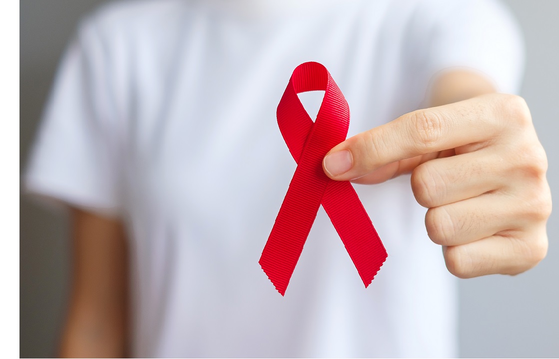 Person holds a red ribbon