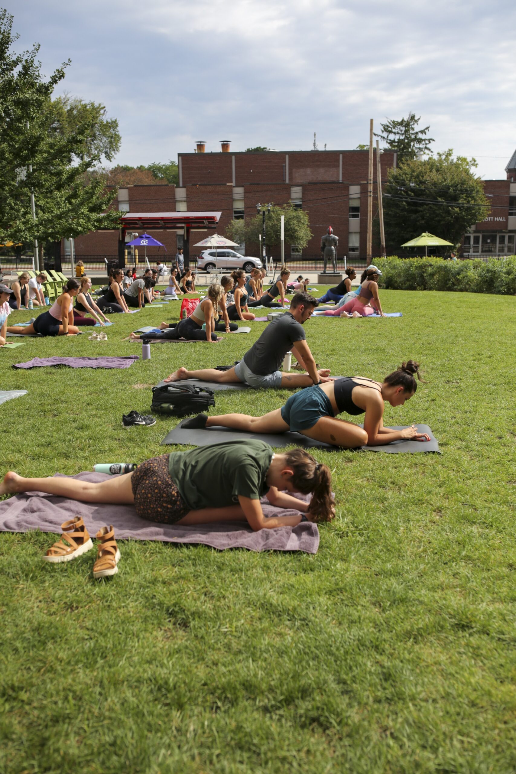 Students do yoga at the Yard outside during move-in week