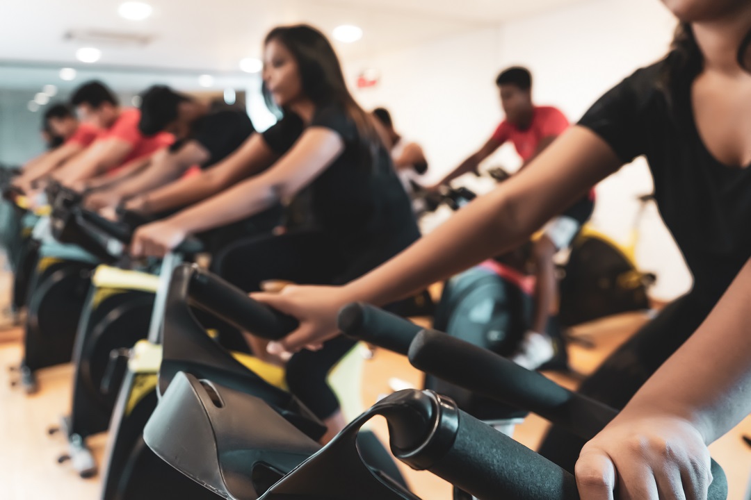 men and women on spin bikes