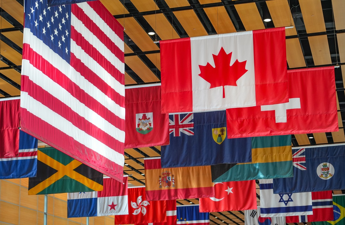 Image of flags from different countries hanging in a large room