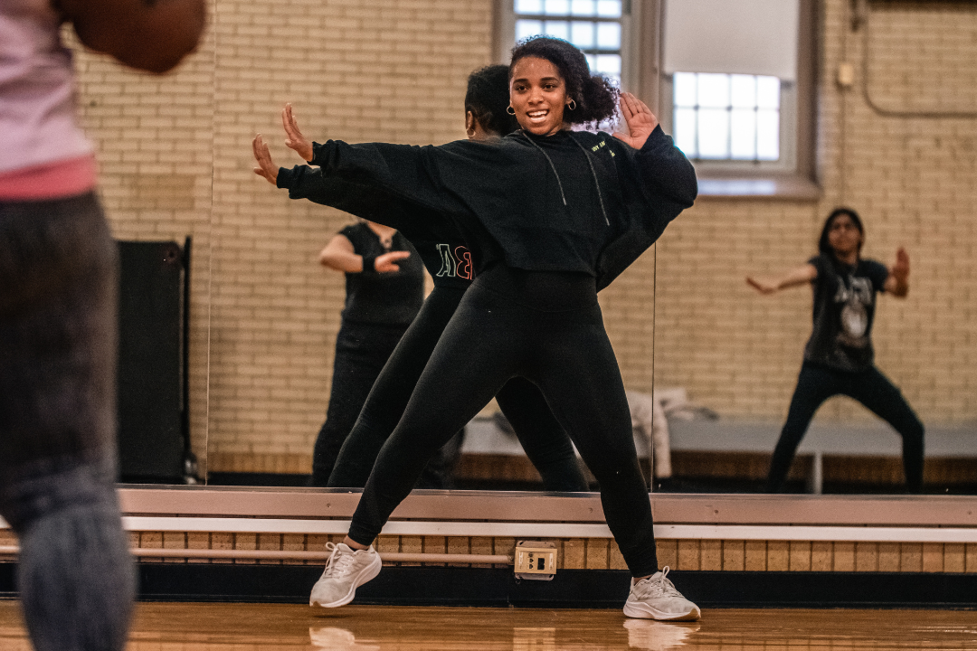 Photo of fitness instructor demonstrating dance moves in a fitness class