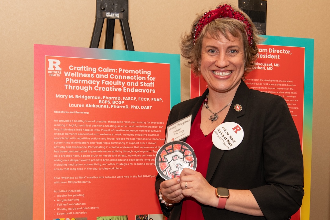 Mary Bridgeman of Ernest Mario School of Pharmacy presents a poster at the 2025 Well-Being in Healthcare Summit.