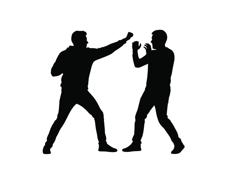 silhouette image of two men in self defense or martial arts poses